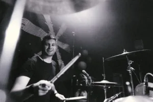 Session Drummer on stage smiling at camera
