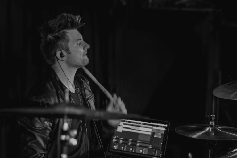 Remote session drummer playing rock beats on drum kit